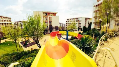 a playground with a slide in a park at William's apartments - cute studio in Sveti Vlas