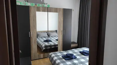 a bedroom with two beds and a mirror at Double Cream Apartment in Tŭnkovo