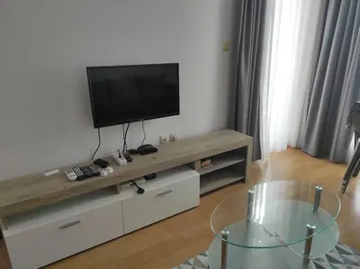 a living room with a flat screen tv on a entertainment center at Double Cream Apartment in Tŭnkovo