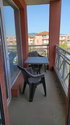 a table and a bench on a balcony at Double Cream Apartment in Tŭnkovo