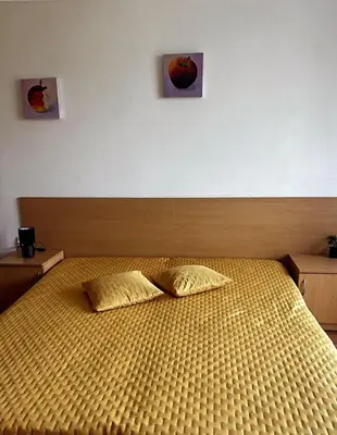 a bedroom with a bed with two pillows on it at The Red Studio in Burgas City