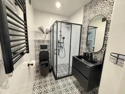 a bathroom with a black sink and a mirror at Luxus Art Apartament Burgas in Burgas City
