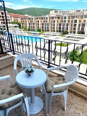 a table and two chairs on a balcony with a view at Premier Fort Beach Sveti Vlas in Sveti Vlas