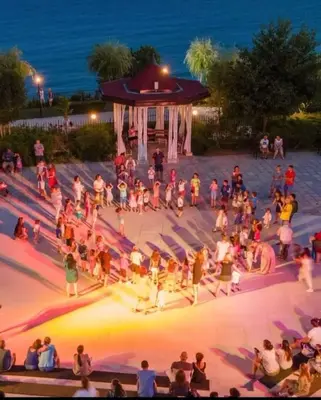 a crowd of people standing around a stage at night at Premier Fort Beach Sveti Vlas in Sveti Vlas
