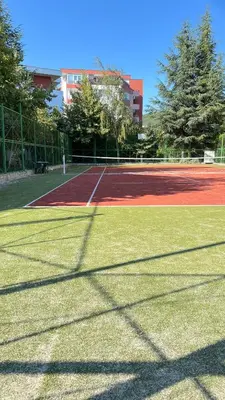 a tennis court with a tennis at Fort Noks PRIVILEGE Apartment in Sveti Vlas