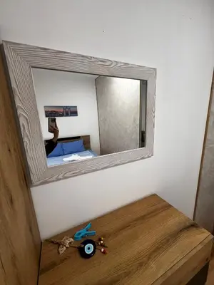 a person taking a picture of a mirror on a wall at Съни Дей ,Слънчев бряг in Burgas City