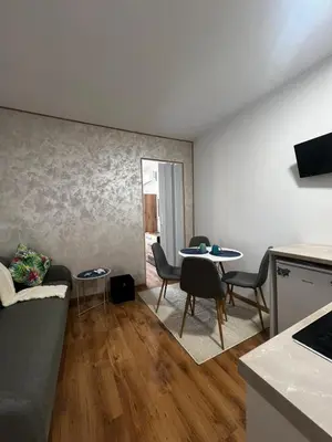 a living room with a couch and a table at Съни Дей ,Слънчев бряг in Burgas City