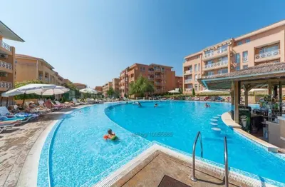 a large swimming pool with people in a hotel at Съни Дей ,Слънчев бряг in Burgas City