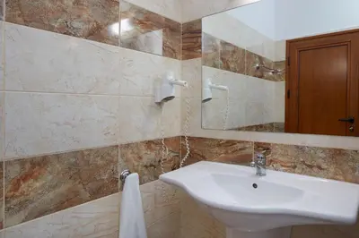 a bathroom with a sink and a mirror at Hotel Lira in Sunny Beach