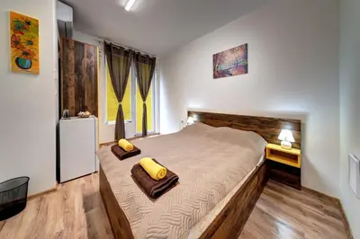 a bedroom with a large bed with two pillows on it at Neptun-Yellow in Primorsko
