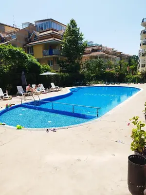 a large blue swimming pool next to a building at Pacyfik3 in Sunny Beach