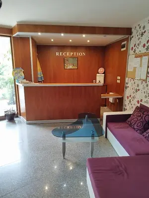 a reception room with a couch and a table at Pacyfik3 in Sunny Beach