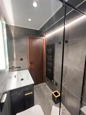 a bathroom with a sink and a shower at Maxim Apartment with Free Parking in Varna City