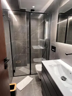 a bathroom with a shower and a toilet and a sink at Maxim Apartment with Free Parking in Varna City