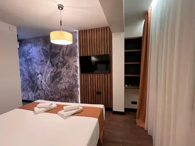 a bedroom with a bed with two towels on it at Maxim Apartment with Free Parking in Varna City