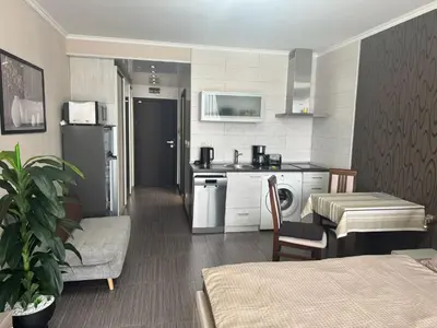 a room with a kitchen and a living room at Lovely Studio with Sea View Grand Hotel Sveti Vlas in Sveti Vlas