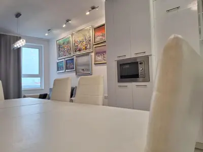 a room with a table and chairs and a television at Central park apartment Сентрал парк апартамент Бургас in Burgas City