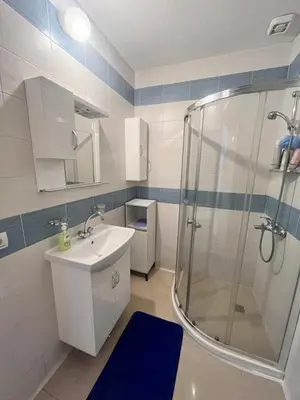 a bathroom with a shower and a sink and a toilet at GALI- beach&mud therapy in Pomorie