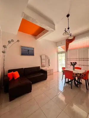 a living room with a couch and a table at GALI- beach&mud therapy in Pomorie