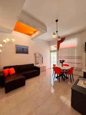 a living room with a couch and a table at GALI- beach&mud therapy in Pomorie