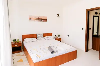 a bedroom with a large bed in a room at Sea Sirena with a Mountain View in Sveti Vlas