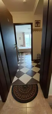 a hallway with a door and a checkered floor at Cozy Studio in Hacienda by Flat Mаnager in Sozopol