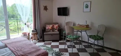 a room with a bed and a table and chairs at Cozy Studio in Hacienda by Flat Mаnager in Sozopol