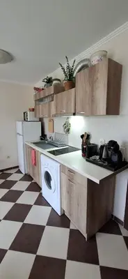 a kitchen with a sink and a washing machine at Cozy Studio in Hacienda by Flat Mаnager in Sozopol