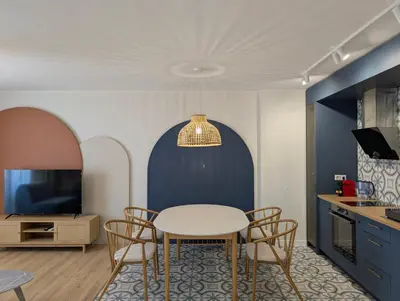 a kitchen and dining room with a table and chairs at Solea Suites in Chernomorets