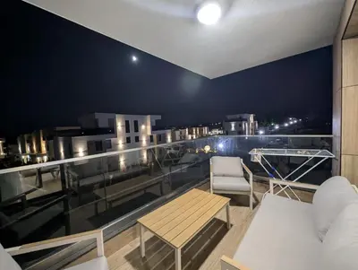 a balcony with a table and a chair on a building at Solea Suites in Chernomorets
