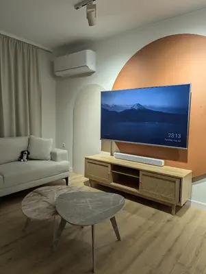 a living room with a large flat screen tv at Solea Suites in Chernomorets