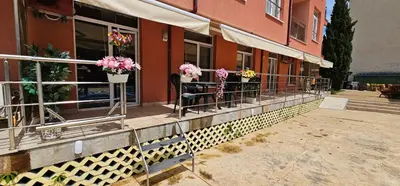 a building with potted flowers on a balcony at Rainbow 2 studio 7 in Sunny Beach