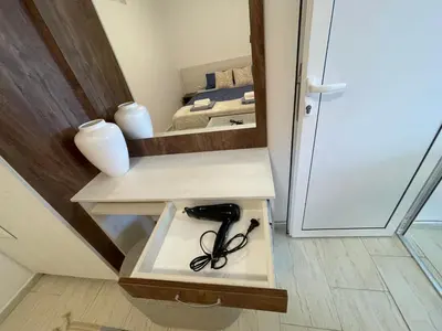 a pair of glasses sitting on a shelf in a room at Апартамент Студио Endless Созопол in Sozopol