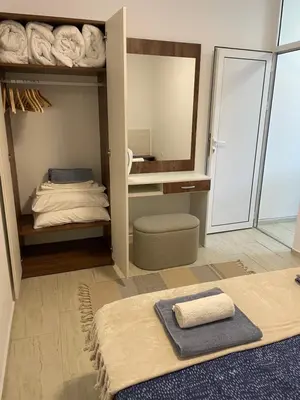 a room with a mirror and a bed with towels at Апартамент Студио Endless Созопол in Sozopol