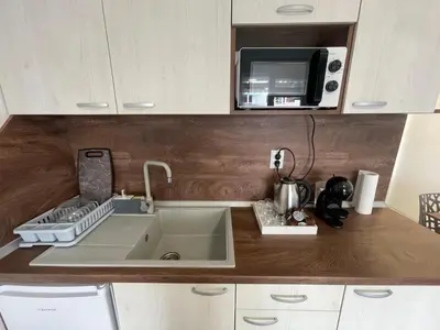a kitchen with a sink and a microwave at Апартамент Студио Endless Созопол in Sozopol