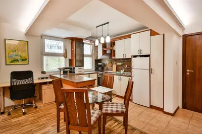 a kitchen with a table and chairs and a refrigerator at Budget Flat in Central Varna in Varna City