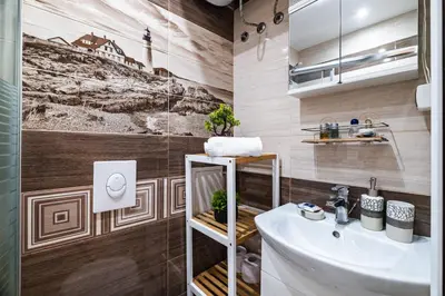 a bathroom with a sink and a toilet and a mirror at Luxury apartment with sea view,FREE parking! in Varna City