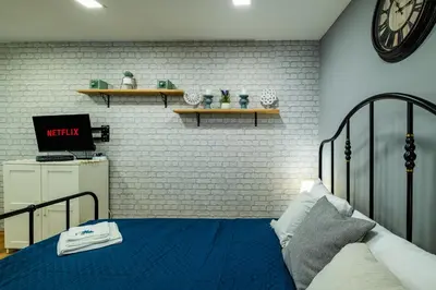 a bedroom with a bed and a clock on the wall at Cozy Studio in Varna City Center in Varna City