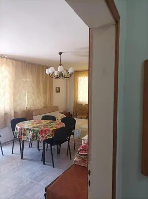 a dining room with a table and chairs in a room at Rita's - family apartment by the sea in Primorsko