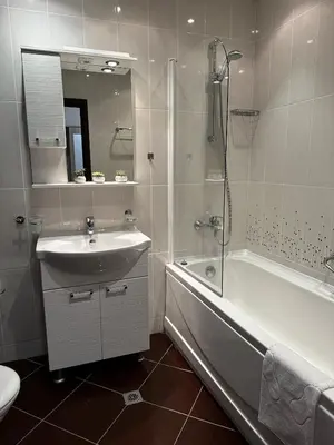 a bathroom with a sink and a shower and a tub at Perfect Sea and Pool View Long Beach Apartment in Shkorpilovtsi