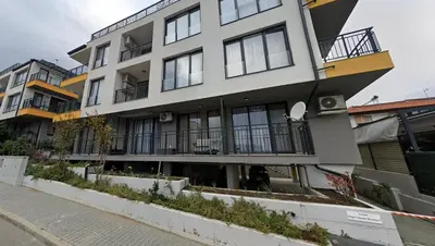 a building with balconies on the side of a street at Boho Apartment Sozopol in Sozopol