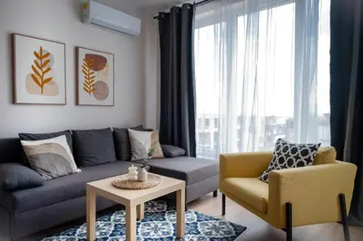 a living room with a couch and a chair and a table at Boho Apartment Sozopol in Sozopol