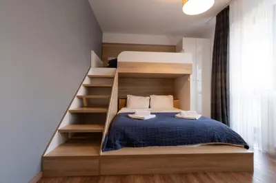 a bedroom with a bunk bed and a staircase at Spacious, free parking, 3min beach, Flora Panorama in Burgas City