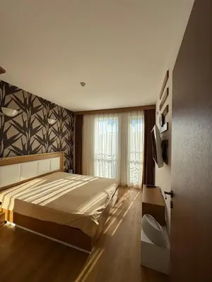a bedroom with a large bed and a window at Nemo's apartment - Sunny Beach in Sunny Beach
