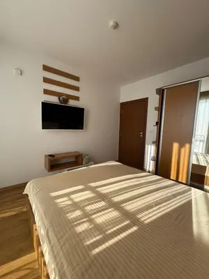 a bedroom with a large bed and a flat screen tv at Nemo's apartment - Sunny Beach in Sunny Beach