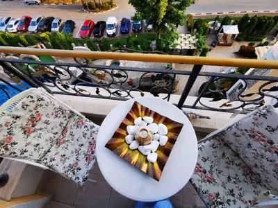 a plate with a flower on it sitting on a balcony at Nemo's apartment - Sunny Beach in Sunny Beach