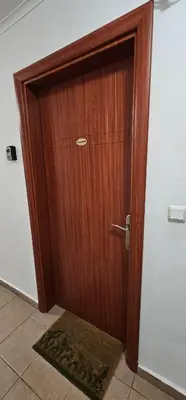 a wooden door in a room with a rug at Rainbow 2 studio 40 in Sunny Beach