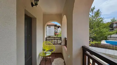 a balcony with a yellow chair and a pool at Exklusive Villa am Sonnenstrand Bulgarien am Schwarzen Meer aheloy Cabernet 1 in Kableshkovo