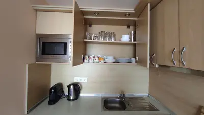 a kitchen with a sink and a microwave at Double Peach Apartment in Sveti Vlas