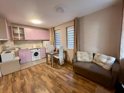 a small living room with a couch and a kitchen at Cozy One-Bedroom Apartment near Burgas Sea Garden in Burgas City